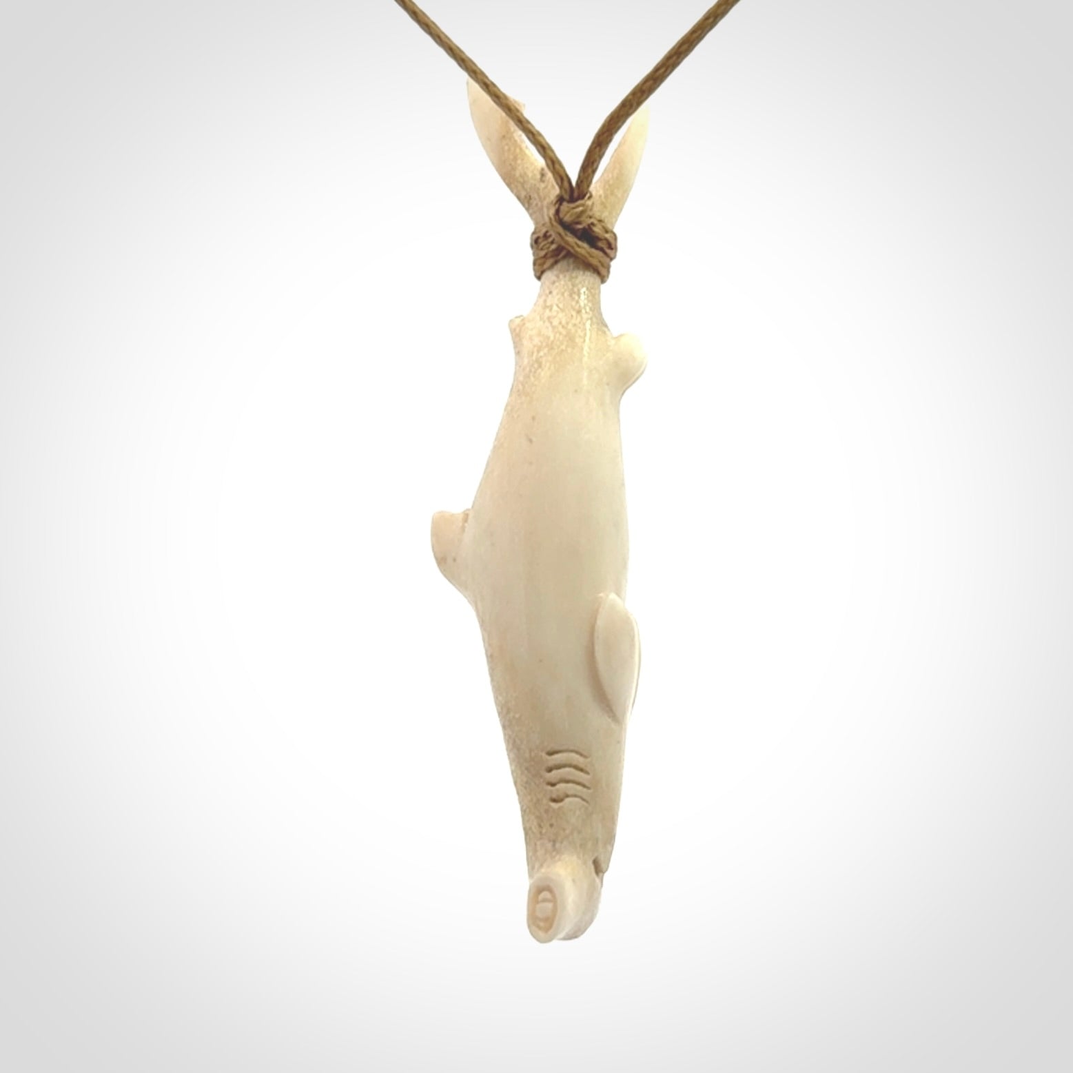 Winghead or hammerhead shark pendant. Hand carved from deer antler by NZ Pacific. Hand carved bone jewellery for sale online.