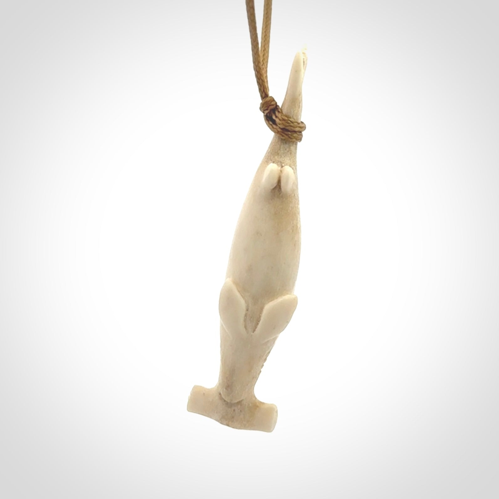 Winghead or hammerhead shark pendant. Hand carved from deer antler by NZ Pacific. Hand carved bone jewellery for sale online.