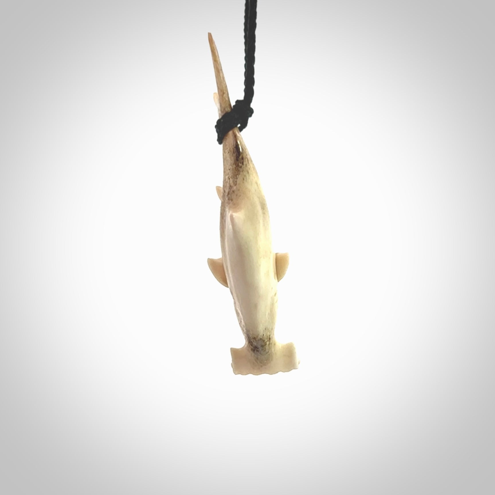 Winghead or hammerhead shark pendant. Hand carved from deer antler by NZ Pacific. Hand carved bone jewellery for sale online.