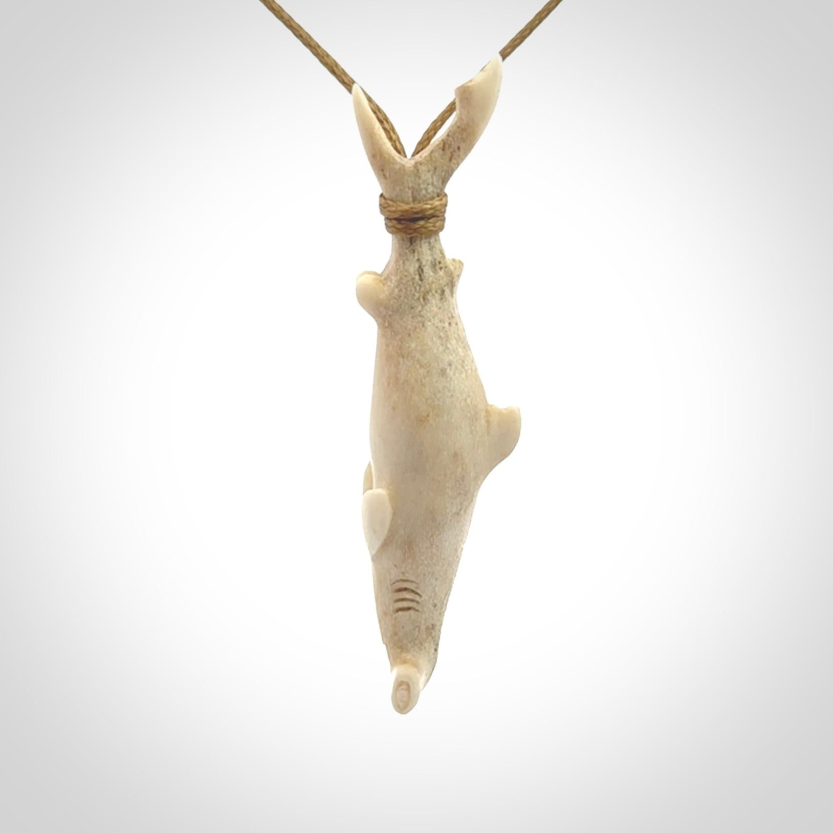 Winghead or hammerhead shark pendant. Hand carved from deer antler by NZ Pacific. Hand carved bone jewellery for sale online.