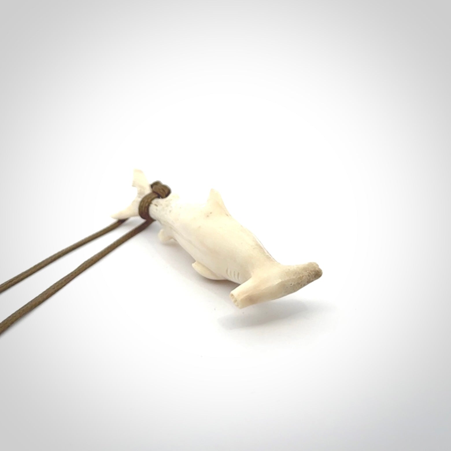 Winghead or hammerhead shark pendant. Hand carved from deer antler by NZ Pacific. Hand carved bone jewellery for sale online.