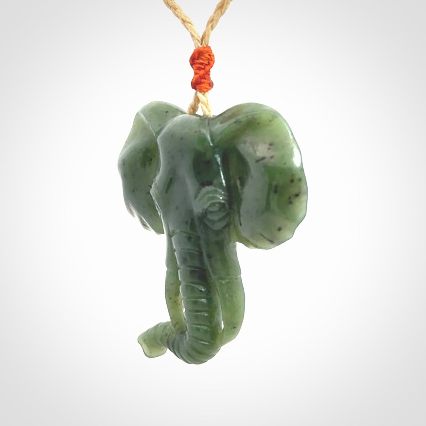 This is a hand made elephant pendant. Carved in a beautiful darker green piece of British Columbian jade. The cord is hand-plaited in a oat colour and is length adjustable. Provided in a woven kete pouch and delivered with express courier.