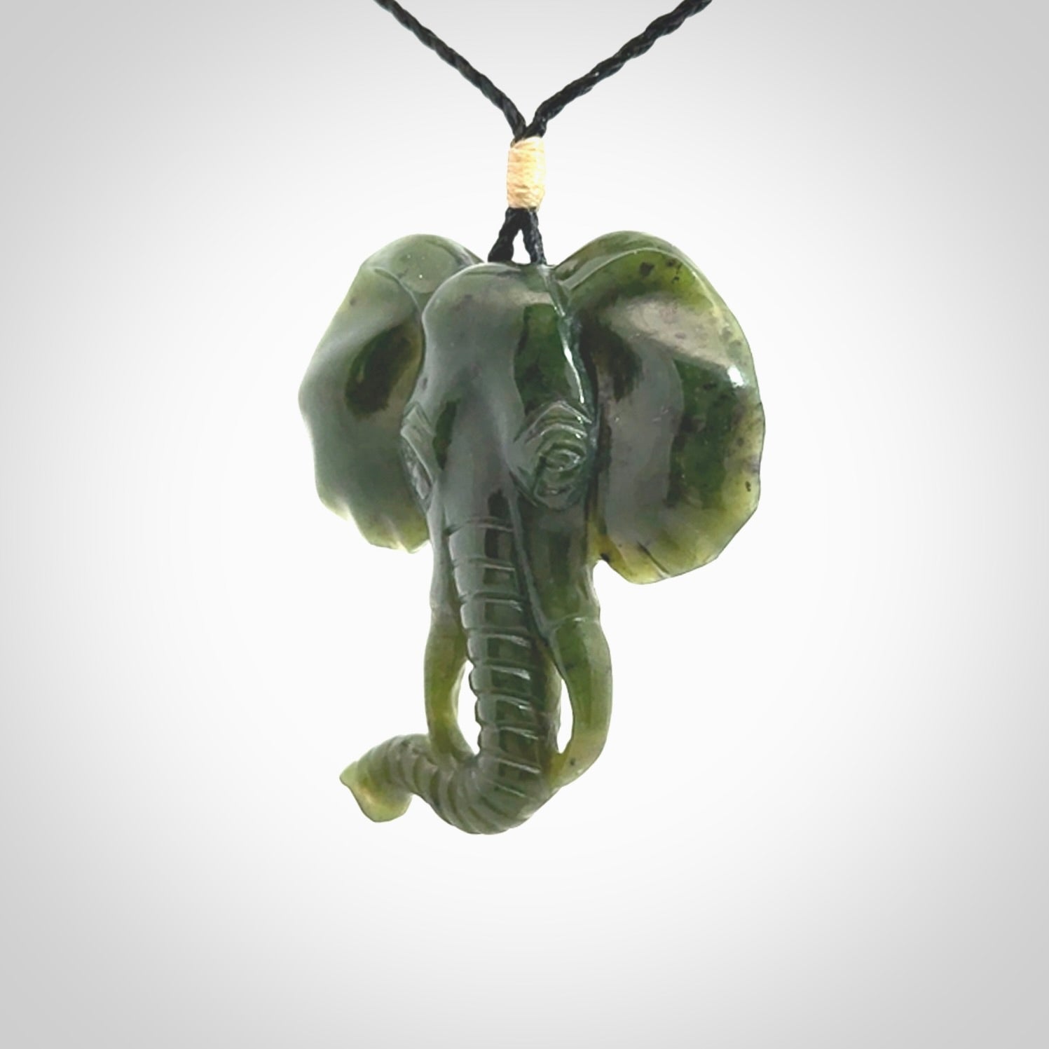 This is a hand made elephant pendant. Carved in a beautiful darker green piece of British Columbian jade. The cord is hand-plaited in a black colour and is length adjustable. Provided in a woven kete pouch and delivered with express courier.