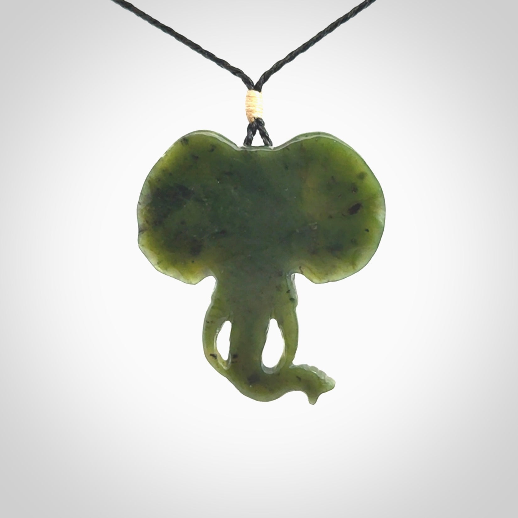 This is a hand made elephant pendant. Carved in a beautiful darker green piece of British Columbian jade. The cord is hand-plaited in a black colour and is length adjustable. Provided in a woven kete pouch and delivered with express courier.