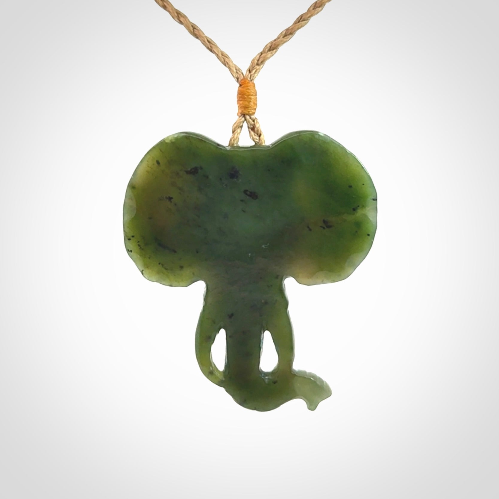 This is a hand made elephant pendant. Carved in a beautiful darker green piece of British Columbian jade. The cord is hand-plaited in a tan colour and is length adjustable. Provided in a woven kete pouch and delivered with express courier.