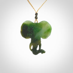 This is a hand made elephant pendant. Carved in a beautiful darker green piece of Aceh jade. The cord is hand-plaited in an Oat colour and is length adjustable. Provided in a woven kete pouch and delivered with express courier.