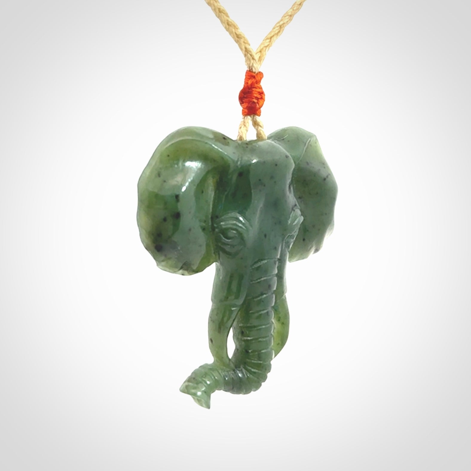 This is a hand made elephant pendant. Carved in a beautiful darker green piece of British Columbian jade. The cord is hand-plaited in a oat colour and is length adjustable. Provided in a woven kete pouch and delivered with express courier.