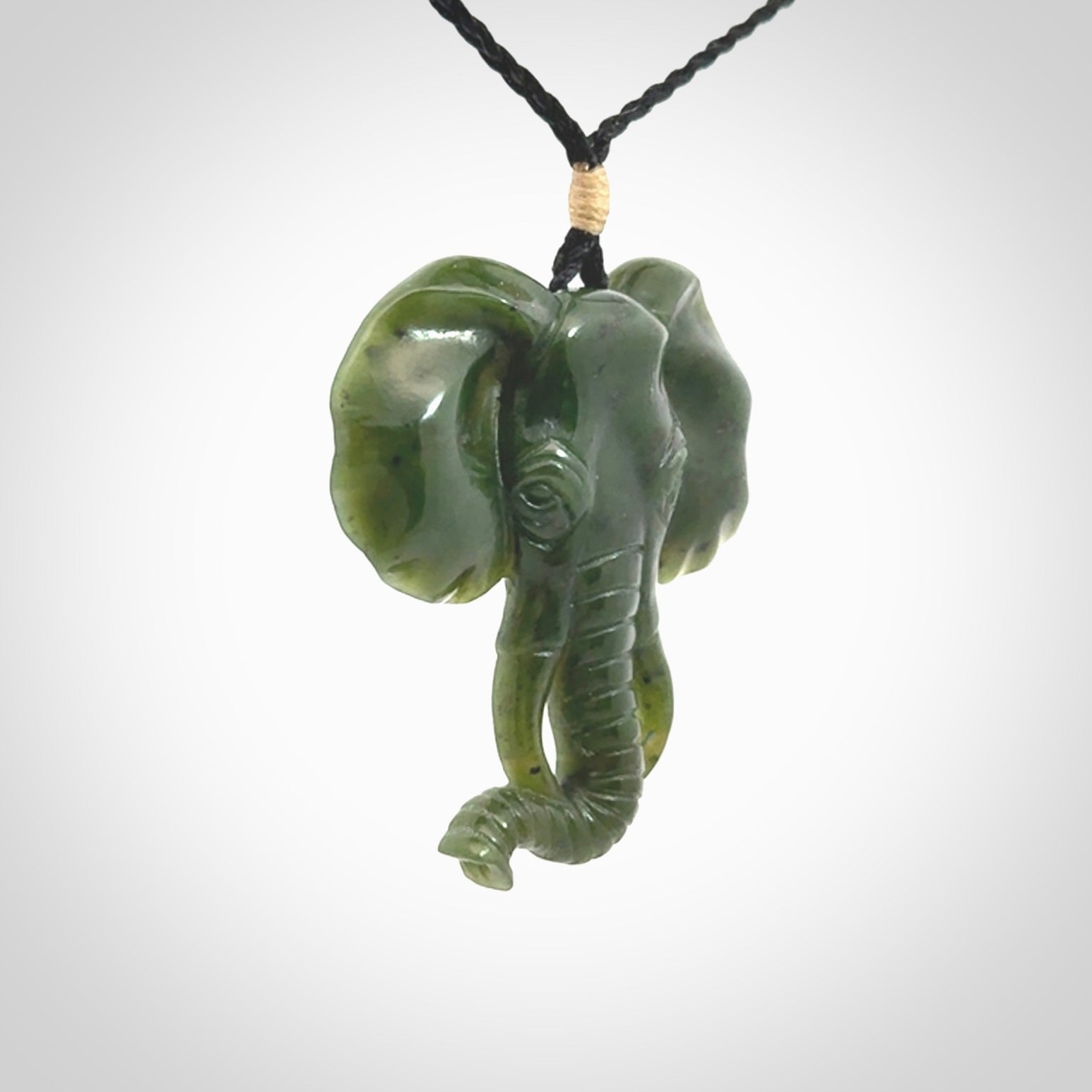 This is a hand made elephant pendant. Carved in a beautiful darker green piece of British Columbian jade. The cord is hand-plaited in a black colour and is length adjustable. Provided in a woven kete pouch and delivered with express courier.
