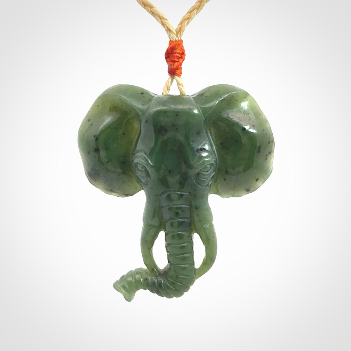 This is a hand made elephant pendant. Carved in a beautiful darker green piece of British Columbian jade. The cord is hand-plaited in a oat colour and is length adjustable. Provided in a woven kete pouch and delivered with express courier.
