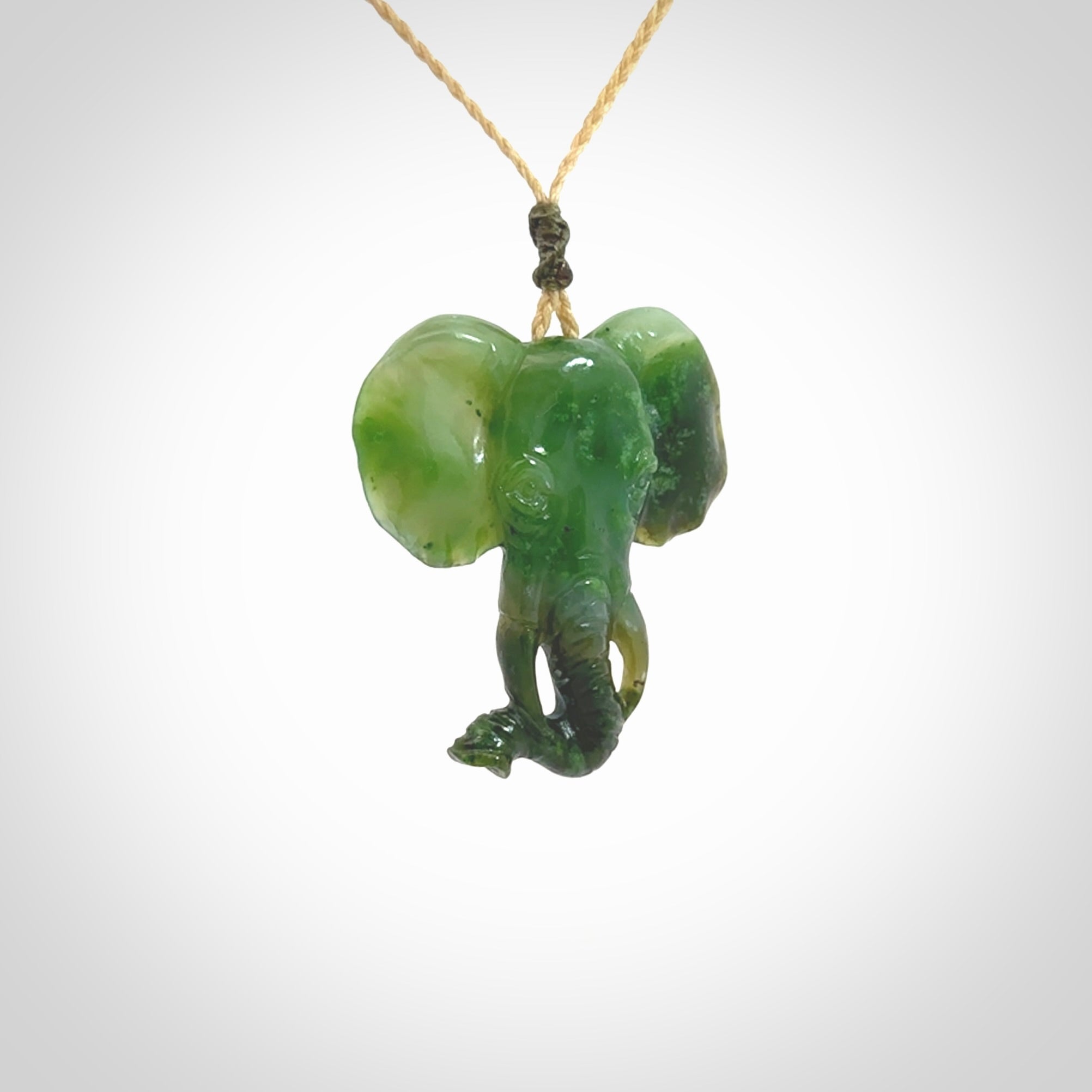This is a hand made elephant pendant. Carved in a beautiful darker green piece of Aceh jade. The cord is hand-plaited in an Oat colour and is length adjustable. Provided in a woven kete pouch and delivered with express courier.
