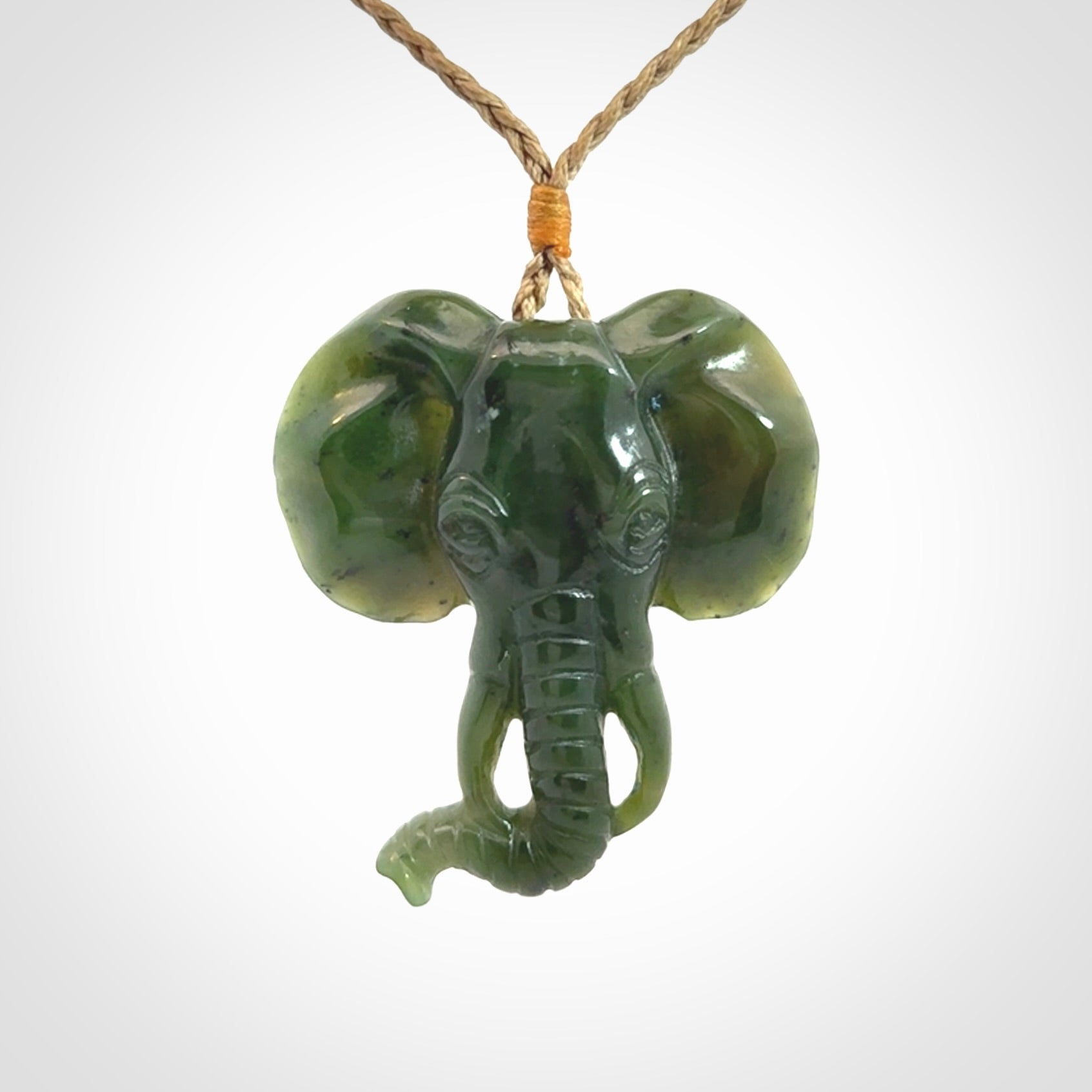 This is a hand made elephant pendant. Carved in a beautiful darker green piece of British Columbian jade. The cord is hand-plaited in a tan colour and is length adjustable. Provided in a woven kete pouch and delivered with express courier.
