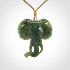 This is a hand made elephant pendant. Carved in a beautiful darker green piece of British Columbian jade. The cord is hand-plaited in a tan colour and is length adjustable. Provided in a woven kete pouch and delivered with express courier.