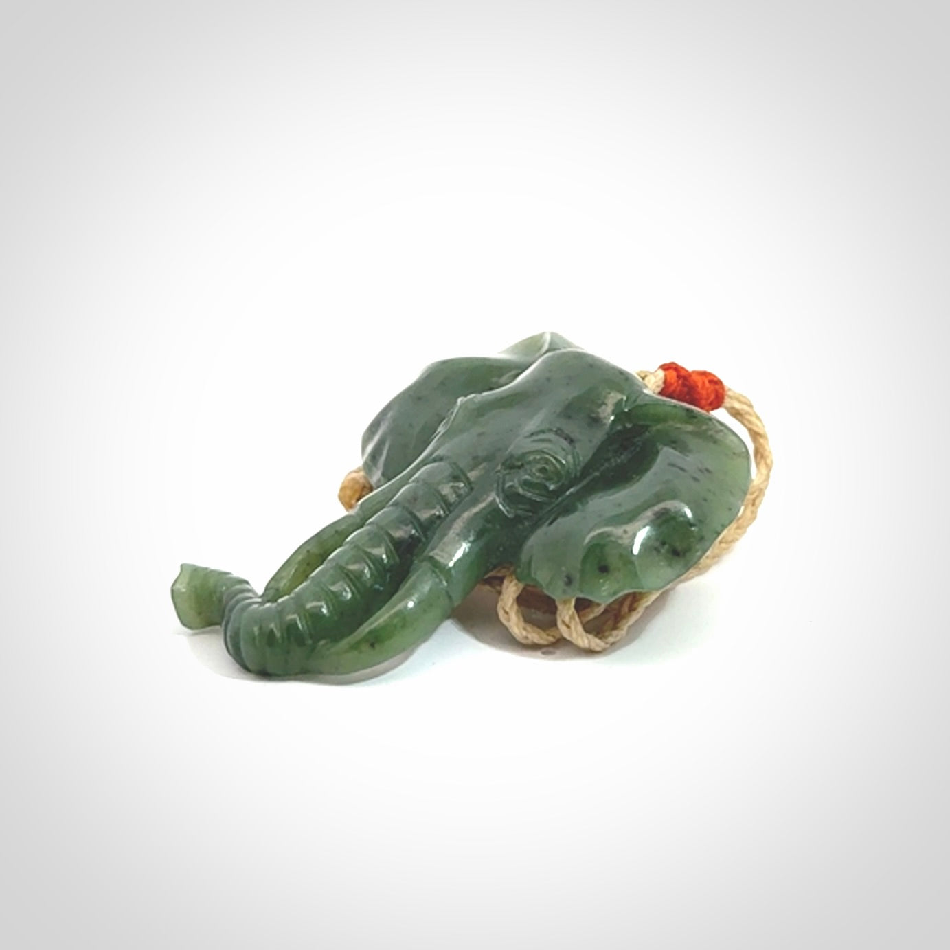 This is a hand made elephant pendant. Carved in a beautiful darker green piece of British Columbian jade. The cord is hand-plaited in a oat colour and is length adjustable. Provided in a woven kete pouch and delivered with express courier.