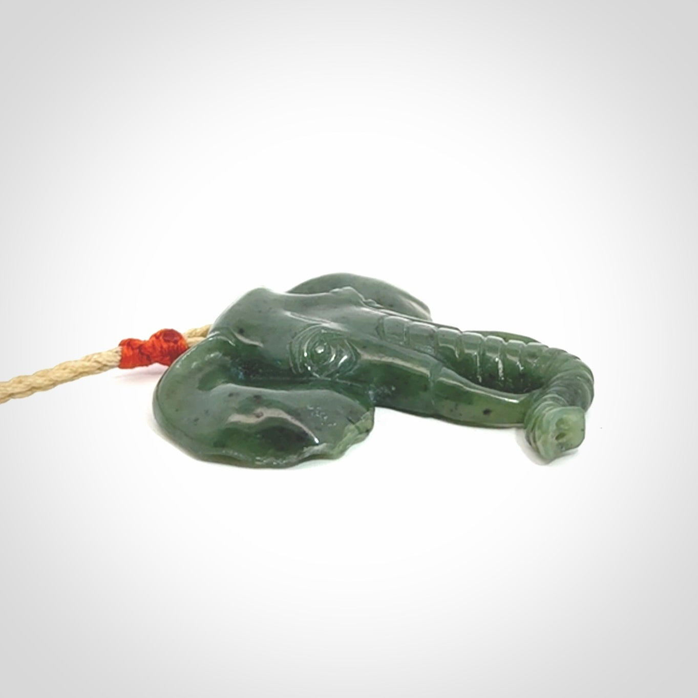 This is a hand made elephant pendant. Carved in a beautiful darker green piece of British Columbian jade. The cord is hand-plaited in a oat colour and is length adjustable. Provided in a woven kete pouch and delivered with express courier.