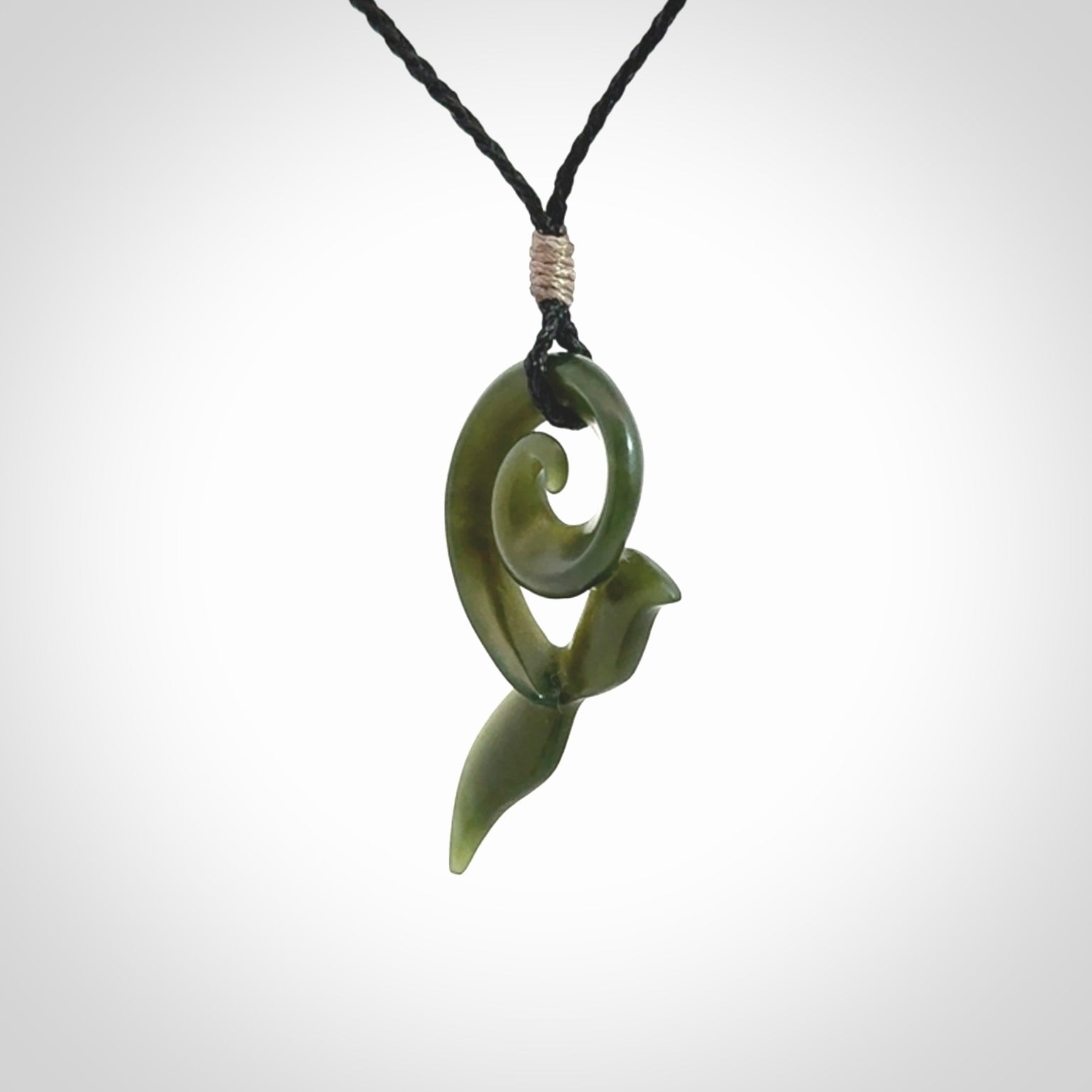 An absolutely stunning jade whale tail pendant