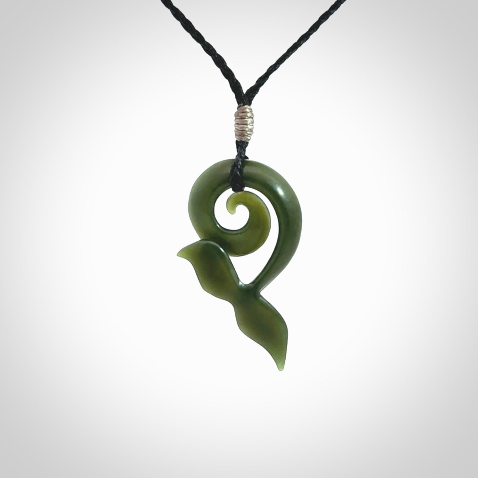 An absolutely stunning jade whale tail pendant