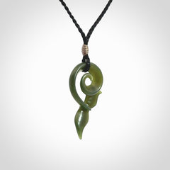 An absolutely stunning jade whale tail pendant