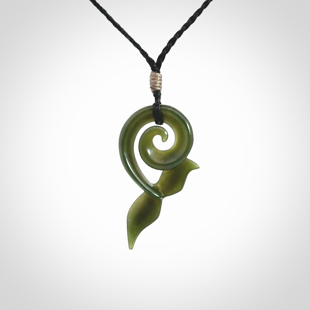 An absolutely stunning jade whale tail pendant