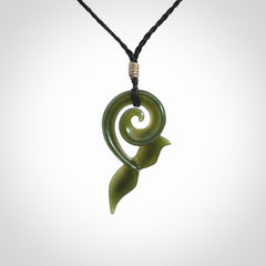 An absolutely stunning jade whale tail pendant