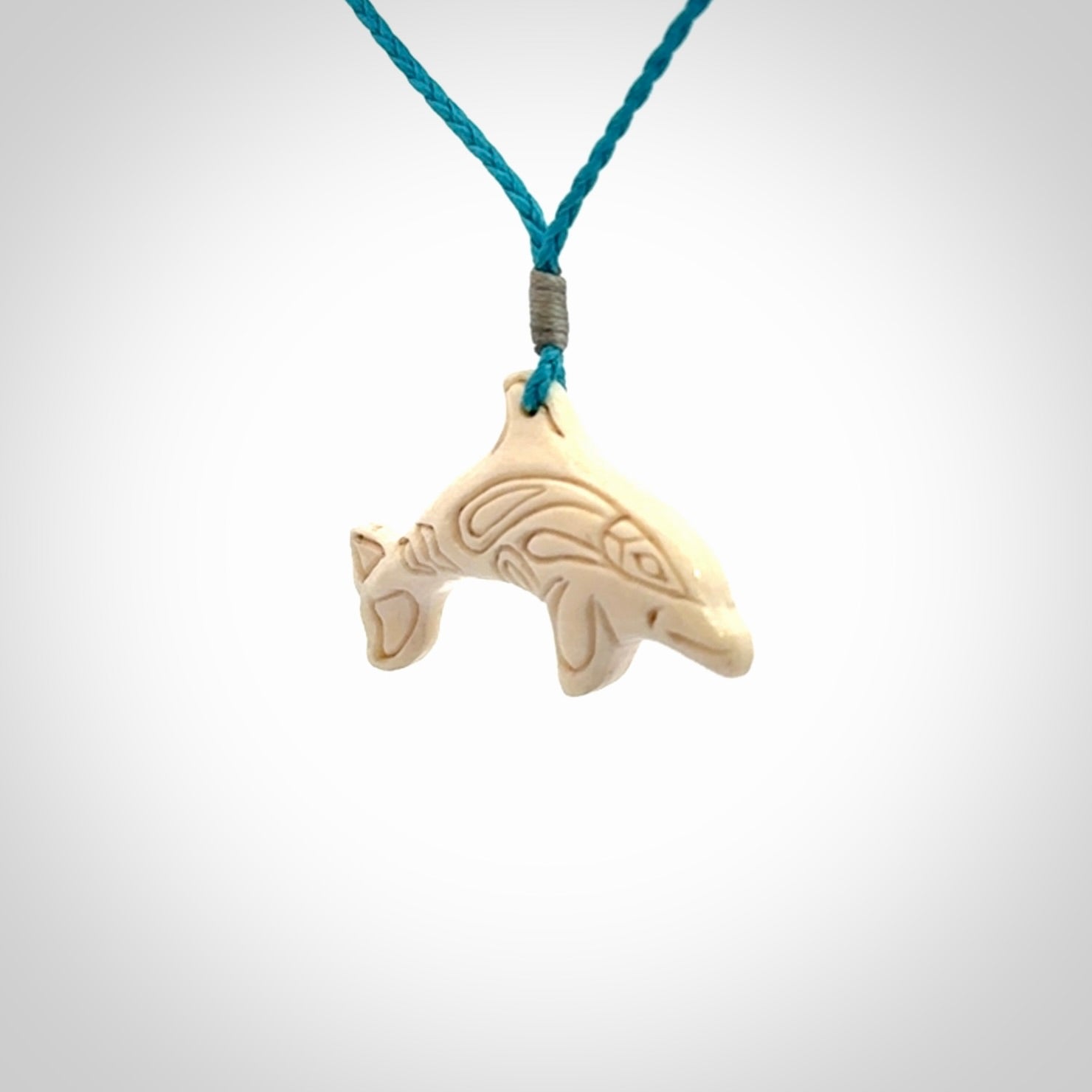 A little dolphin pendant, carved in mammoth tusk