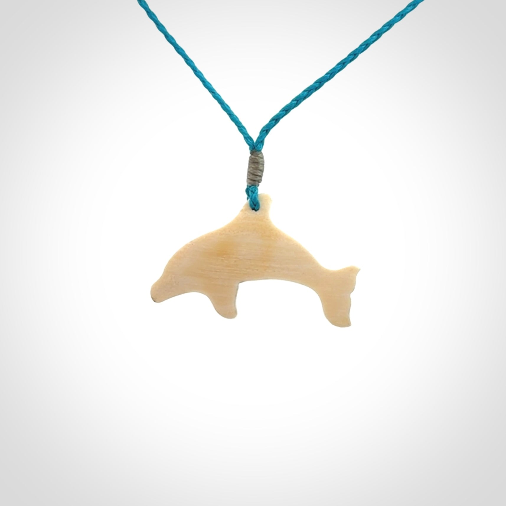 A little dolphin pendant, carved in mammoth tusk