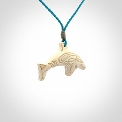 A little dolphin pendant, carved in mammoth tusk