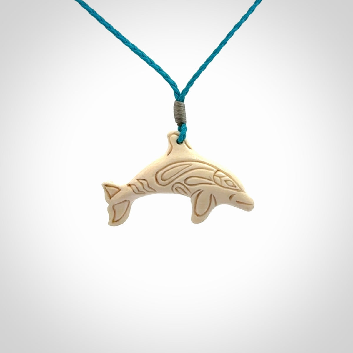 A little dolphin pendant, carved in mammoth tusk