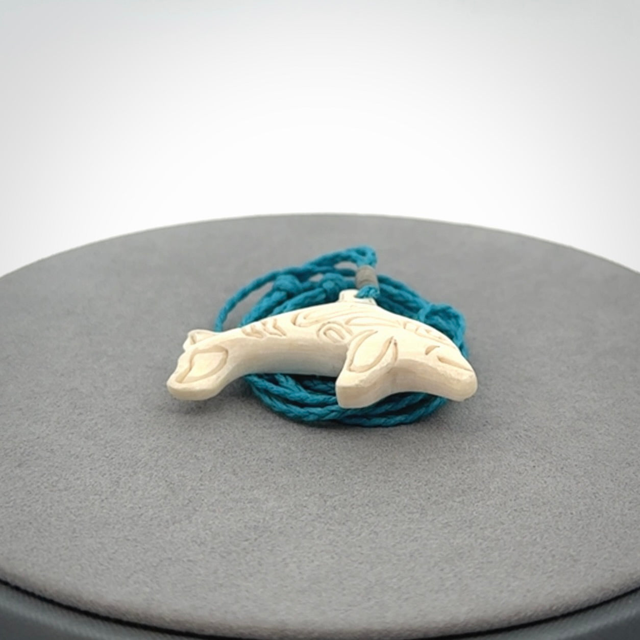 A little dolphin pendant, carved in mammoth tusk
