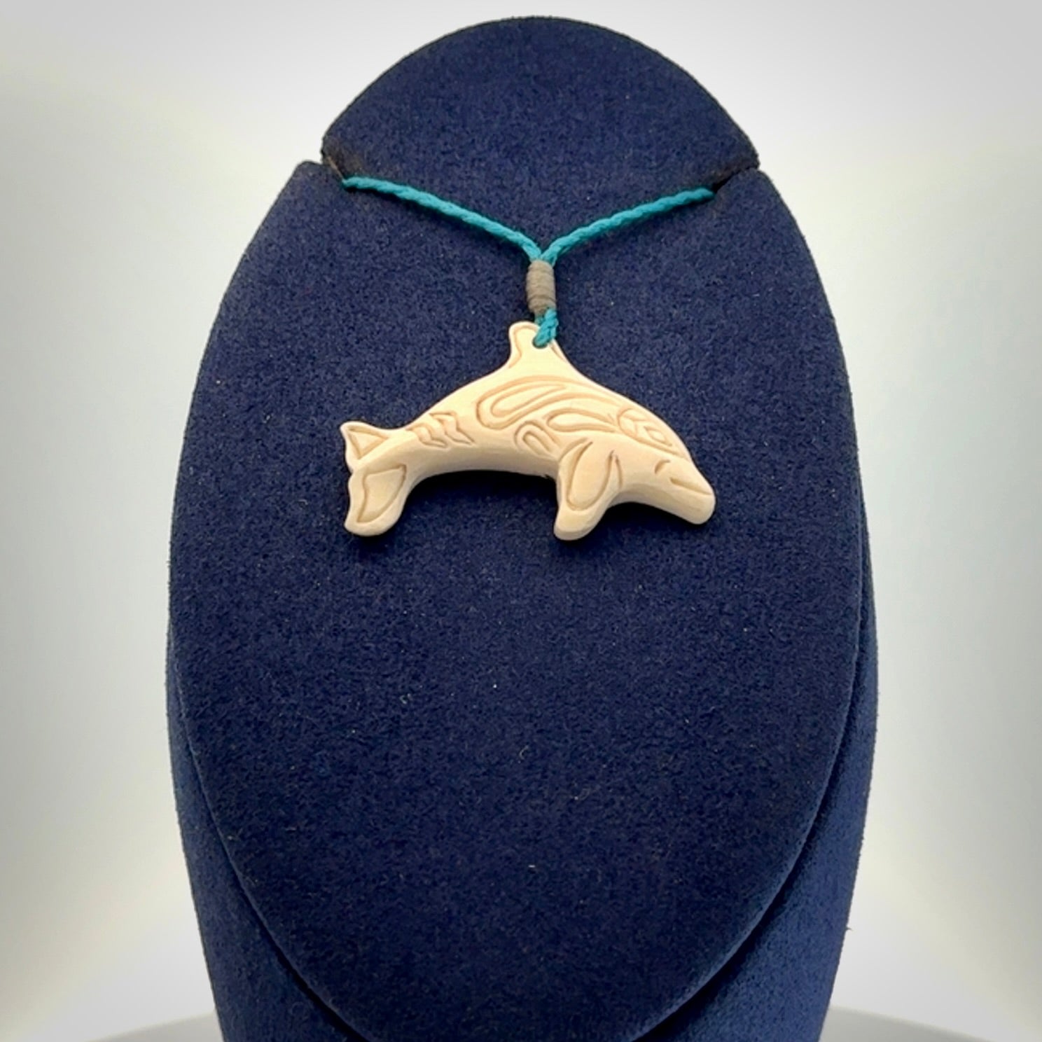 A little dolphin pendant, carved in mammoth tusk