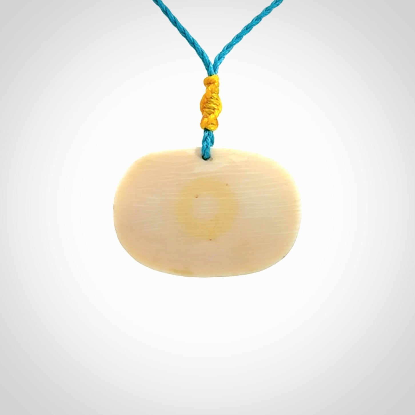 A beautiful dolphin pendant carved in mammoth tusk