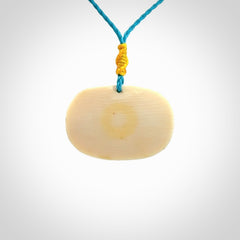 A beautiful dolphin pendant carved in mammoth tusk
