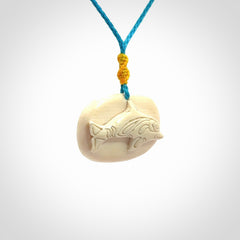 A beautiful dolphin pendant carved in mammoth tusk
