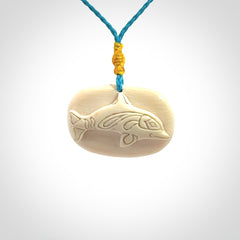 A beautiful dolphin pendant carved in mammoth tusk
