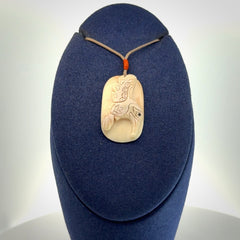A wonderful pendant, carved in mammoth tusk