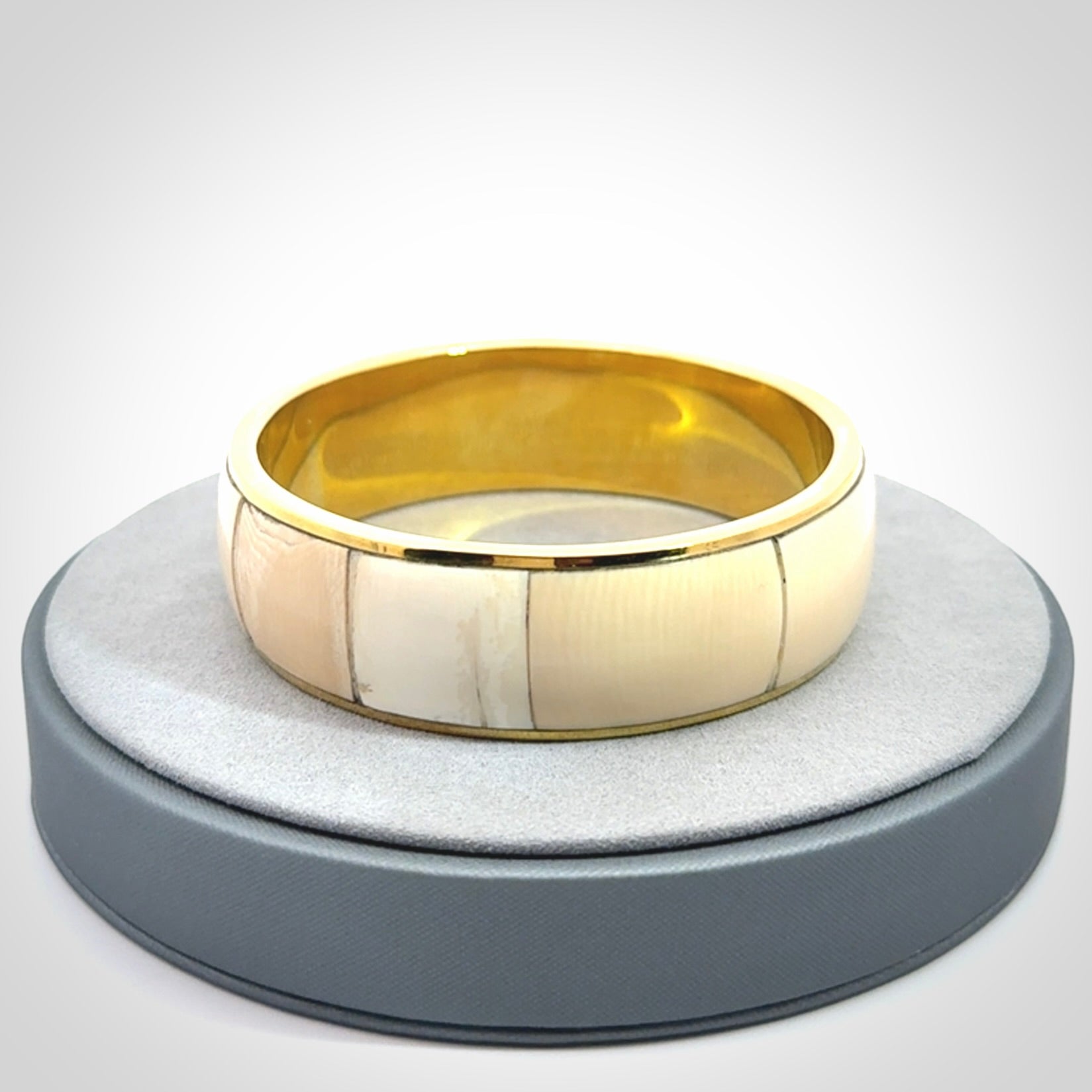This piece is a hand made bracelet. It is made from selected pieces of woolly mammoth tusk which we have cut and polished and then inset into a brass bracelet. It is a very striking piece one of a kind and truly beautiful.