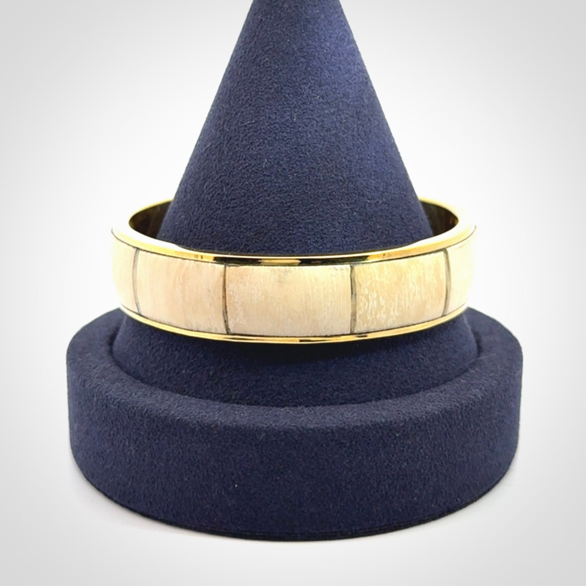 This piece is a hand made bracelet. It is made from selected pieces of woolly mammoth tusk which we have cut and polished and then inset into a brass bracelet. It is a very striking piece one of a kind and truly beautiful.