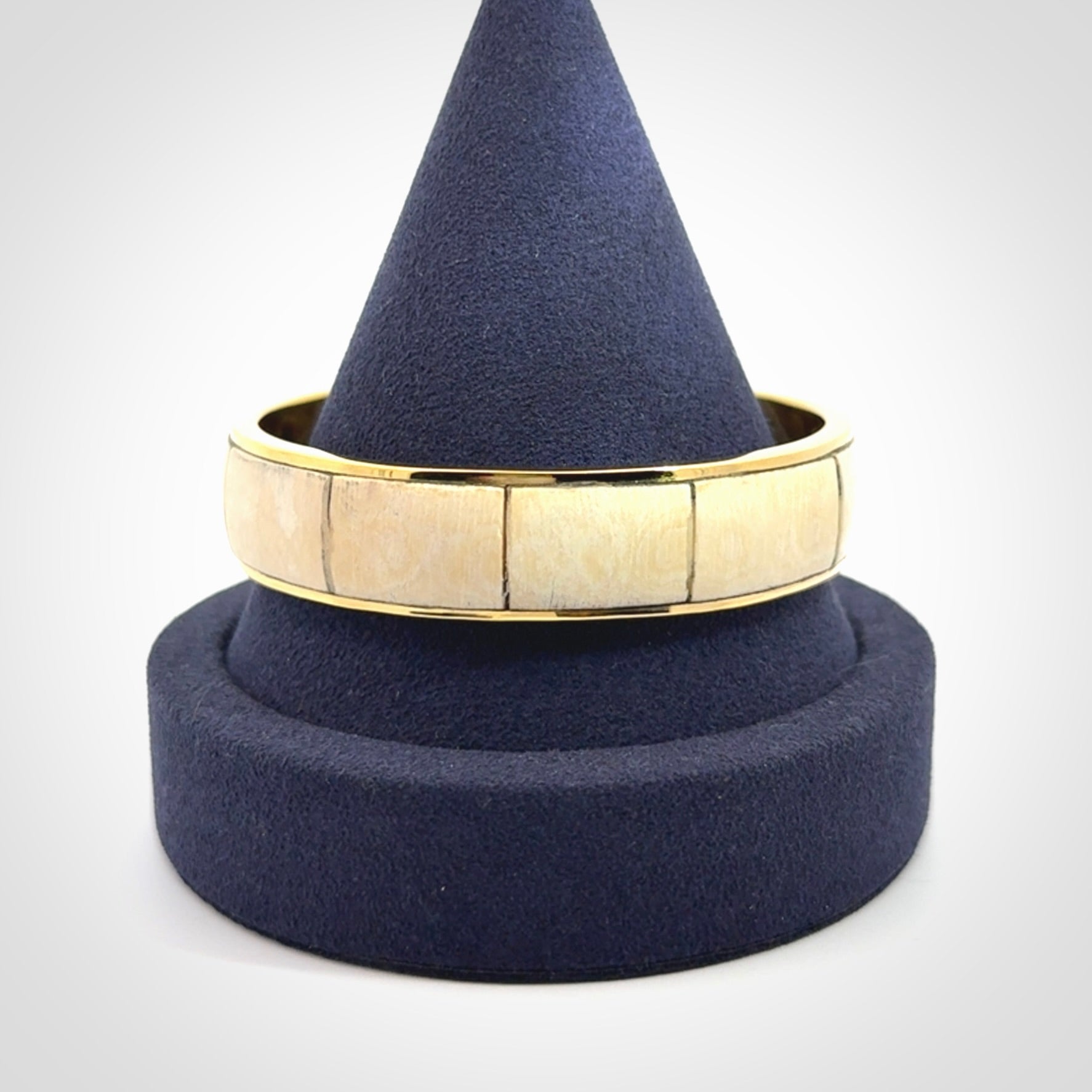 This piece is a hand made bracelet. It is made from selected pieces of woolly mammoth tusk which we have cut and polished and then inset into a brass bracelet. It is a very striking piece one of a kind and truly beautiful.