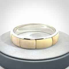 This piece is a hand made bracelet. It is made from selected pieces of woolly mammoth tusk which we have cut and polished and then inset into a sterling silver bracelet. It is a very striking piece one of a kind and truly beautiful.