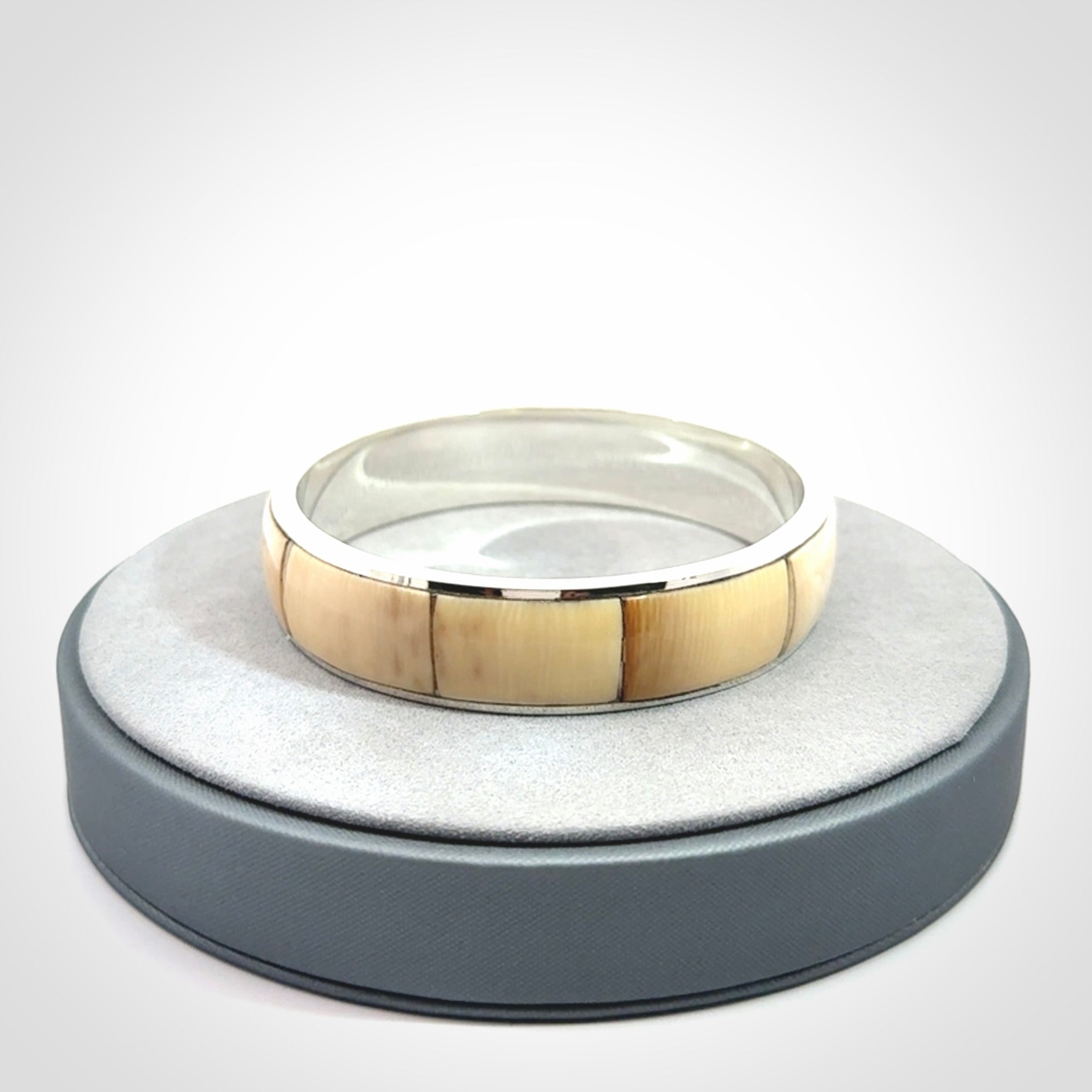 This piece is a hand made bracelet. It is made from selected pieces of woolly mammoth tusk which we have cut and polished and then inset into a sterling silver bracelet. It is a very striking piece one of a kind and truly beautiful.