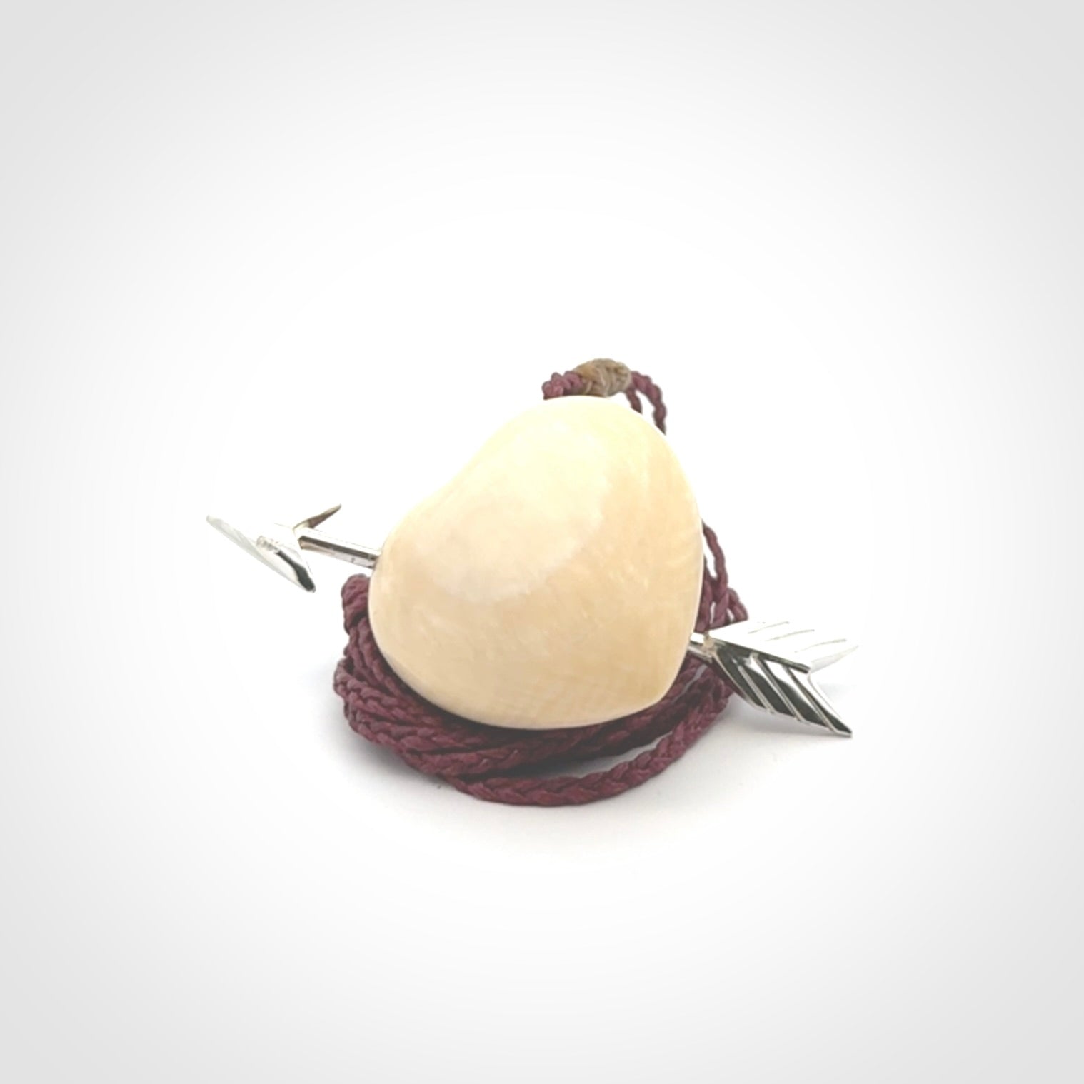 Hand crafted contemporary woolly mammoth tusk heart with sterling silver arrow necklace. This necklace is provided with an adjustable plum cord.