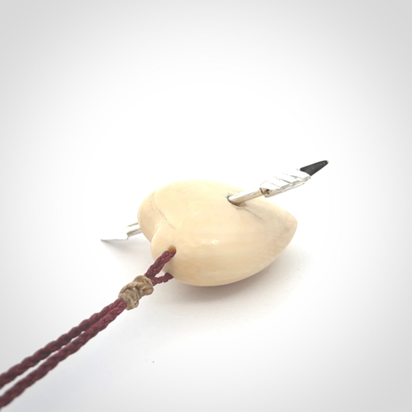 Hand crafted contemporary woolly mammoth tusk heart with sterling silver arrow necklace. This necklace is provided with an adjustable plum cord.