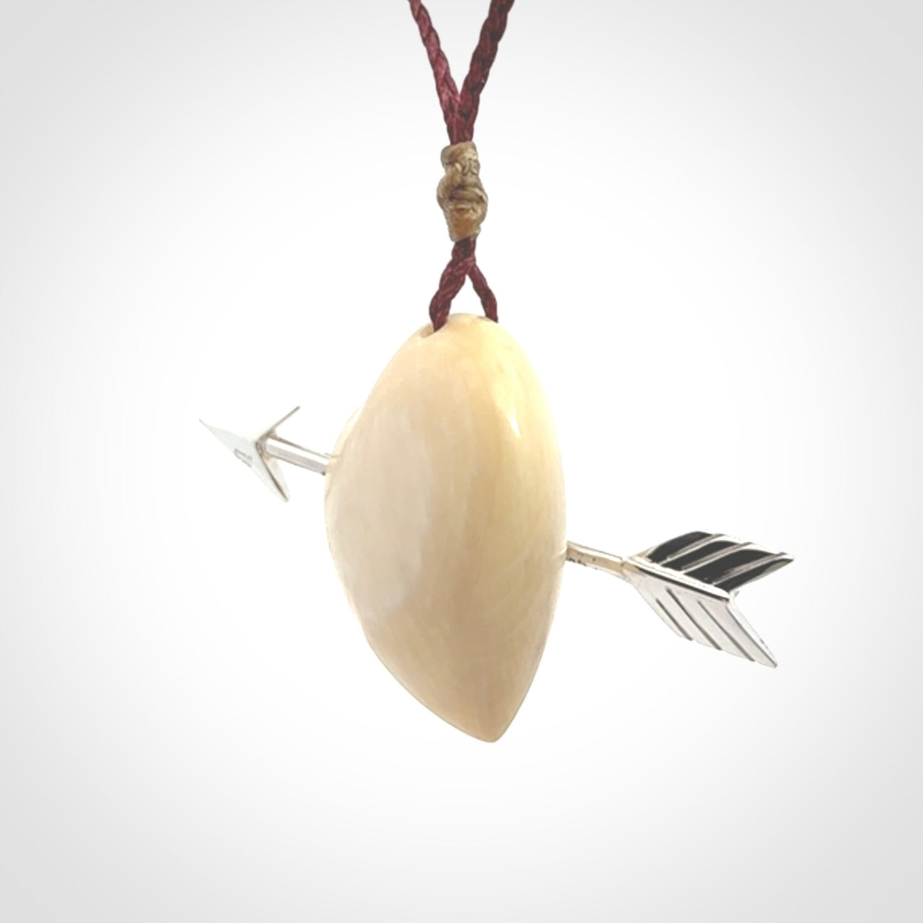 Hand crafted contemporary woolly mammoth tusk heart with sterling silver arrow necklace. This necklace is provided with an adjustable plum cord.