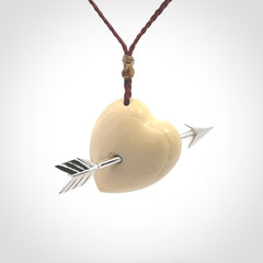 Hand crafted contemporary woolly mammoth tusk heart with sterling silver arrow necklace. This necklace is provided with an adjustable plum cord.
