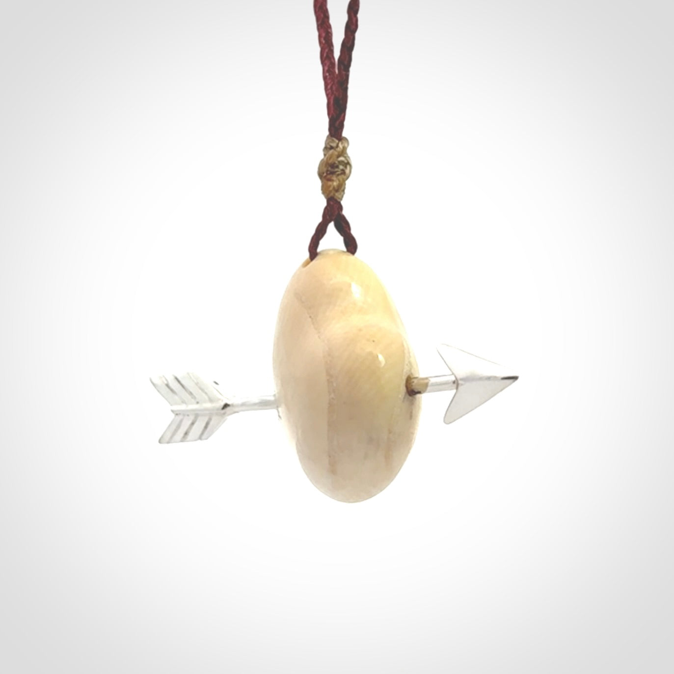 Hand crafted contemporary woolly mammoth tusk heart with sterling silver arrow necklace. This necklace is provided with an adjustable plum cord.