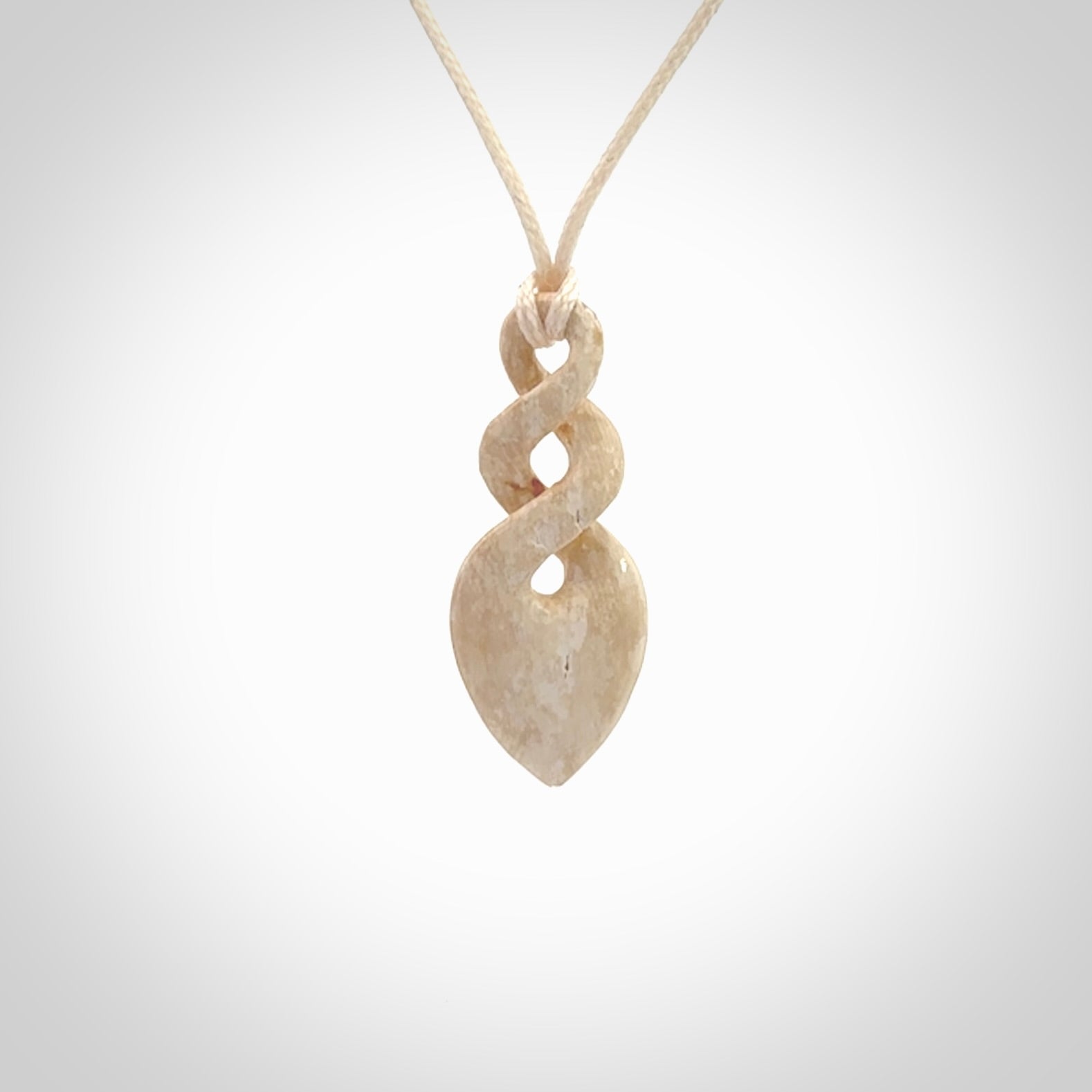 Hand carved woolly mammoth tusk twist pendant. Hand made jewellery made by NZ Pacific and for sale online.