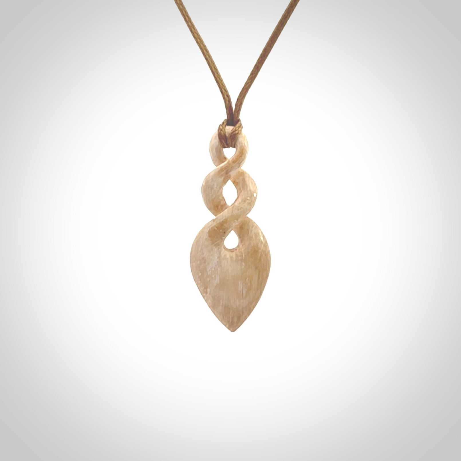 Hand carved woolly mammoth tusk twist pendant. Hand made jewellery made by NZ Pacific and for sale online.