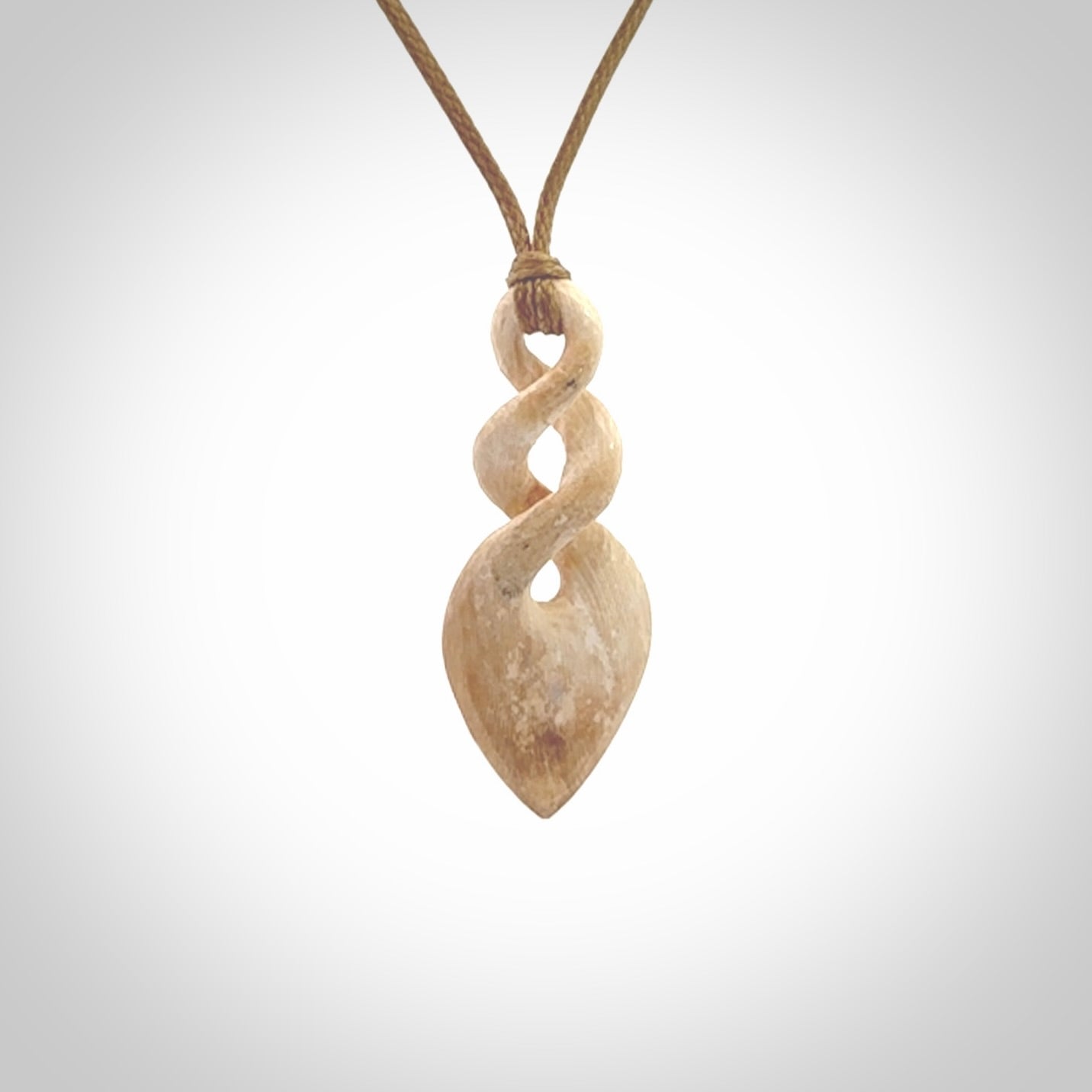 Hand carved woolly mammoth tusk twist pendant. Hand made jewellery made by NZ Pacific and for sale online.