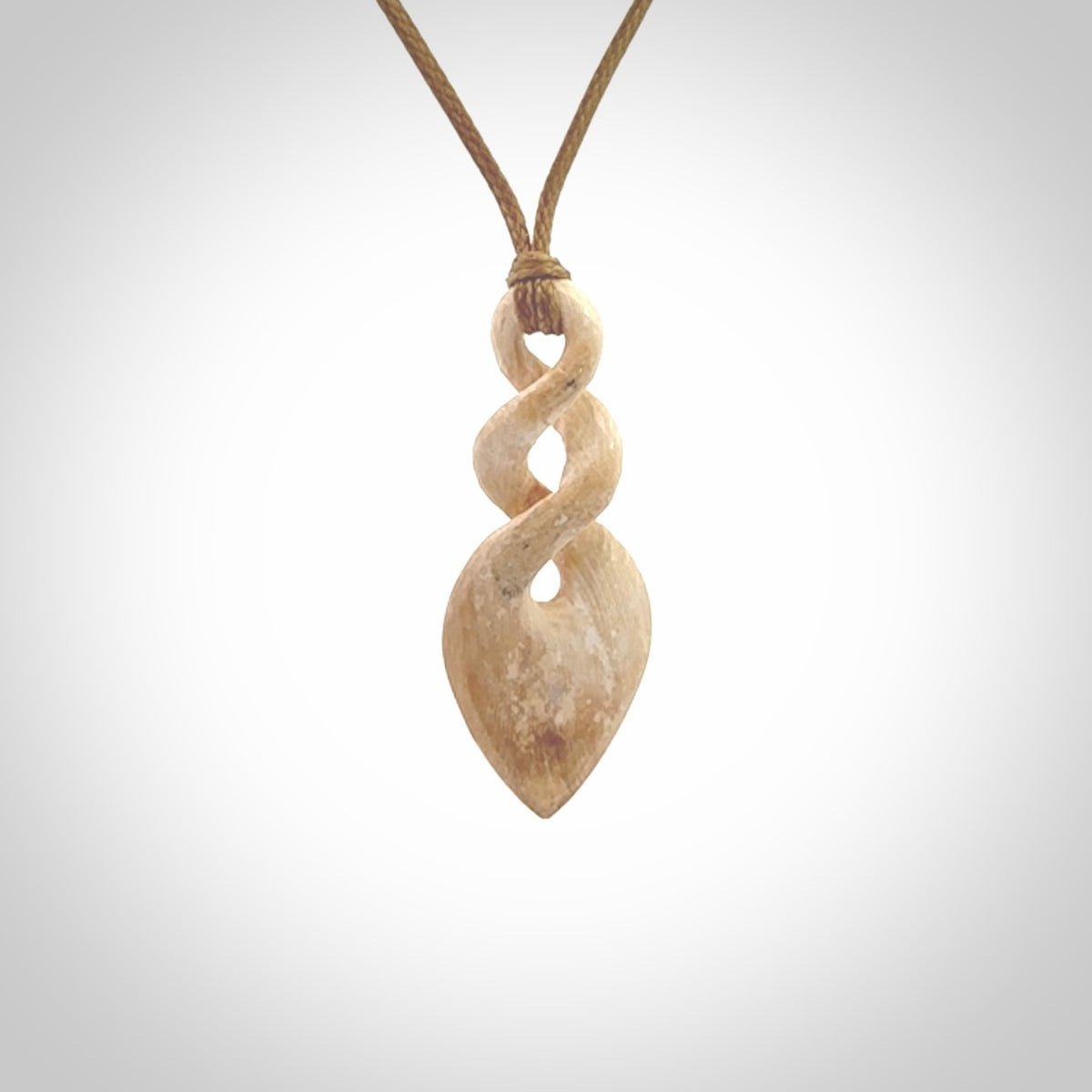 Hand carved woolly mammoth tusk twist pendant. Hand made jewellery made by NZ Pacific and for sale online.
