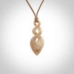 Hand carved woolly mammoth tusk twist pendant. Hand made jewellery made by NZ Pacific and for sale online.