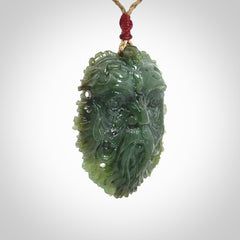This picture shows a large hand carved forest man face pendant. The cord is hand plaited and adjustable.